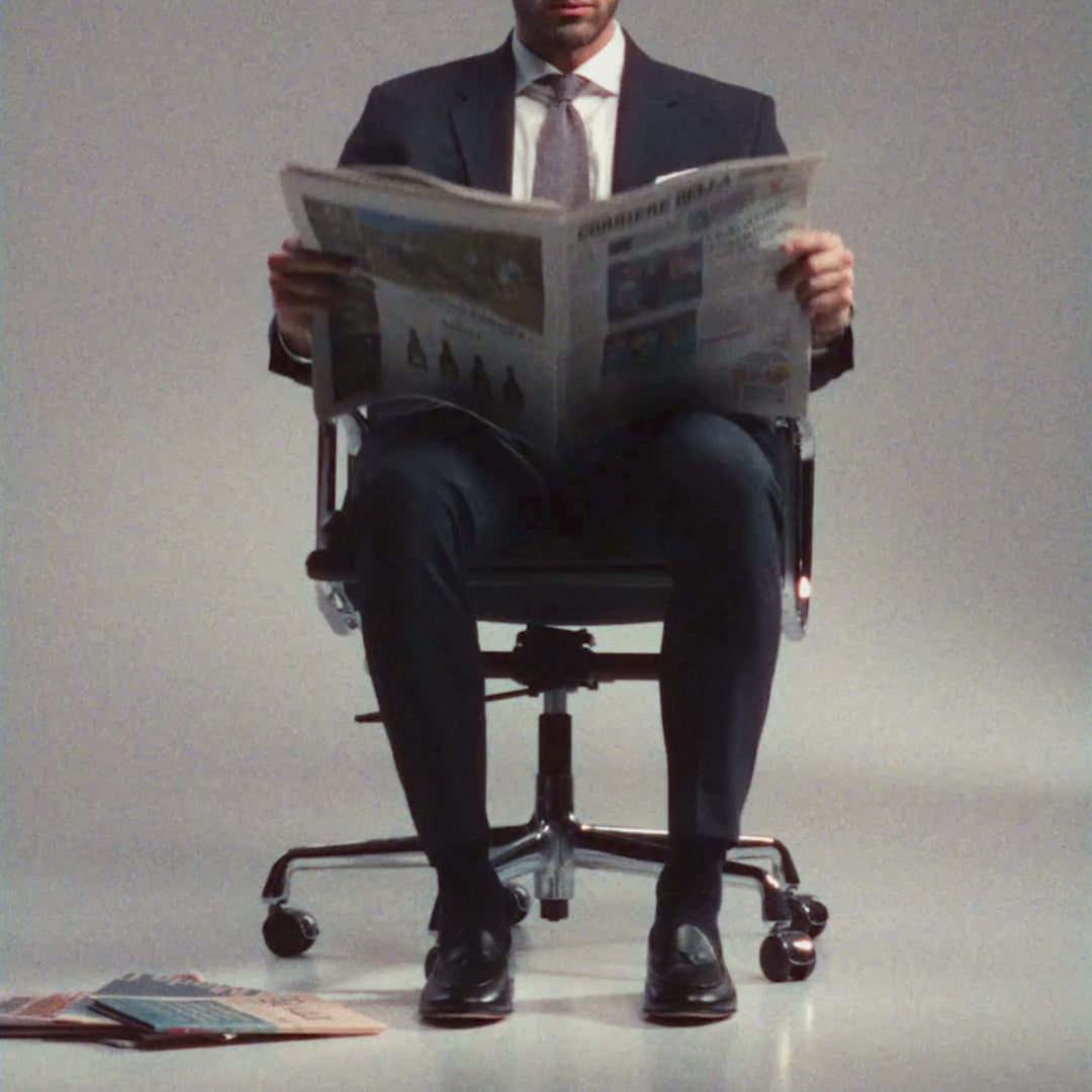 Video of a man in a chair wearing a pair of black leather dress shoes